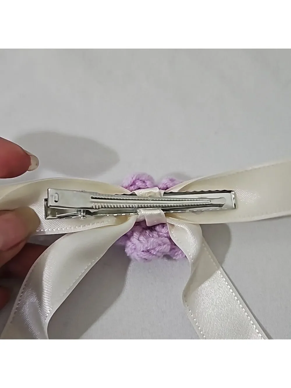 Hand Crafted Ivory Bow with Purple Crochet Flower